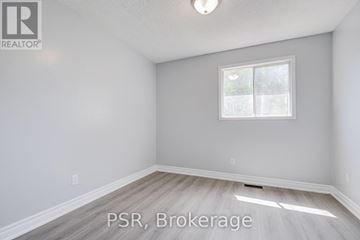 Oshawa (Mclaughlin) apartment for rent - A room with a window and a wooden floor.