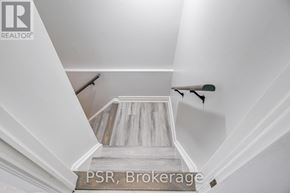 Oshawa (Mclaughlin) apartment for rent - A staircase with a wooden floor and white walls.