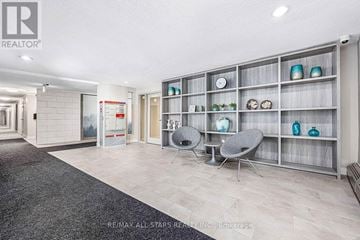 Whitchurch-Stouffville (Stouffville) multi-family for rent - A modern living room with a grey carpet and a grey sofa.