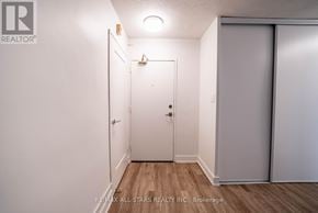 Whitchurch-Stouffville (Stouffville) multi-family for rent - A white door is in a room with a wooden floor.