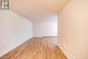 Whitchurch-Stouffville (Stouffville) multi-family for rent - A room with wooden flooring and white walls.