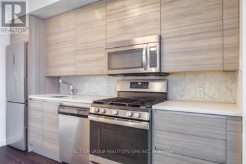 Toronto (Waterfront Communities) condo for rent - A modern kitchen with a stainless steel oven and microwave.