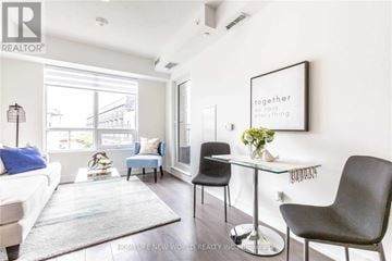 Markham (Unionville) condo for rent - A modern living room with a glass table and a framed picture on the wall.