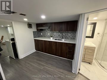 Toronto (Junction Area) apartment for rent - A modern kitchen with dark wood cabinets and a white countertop.