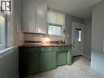 Windsor apartment for rent - A kitchen with green cabinets and a tiled floor.
