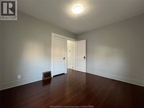 Windsor apartment for rent - A room with a wooden floor and a white door.