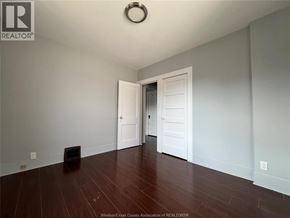 Windsor apartment for rent - A room with a wooden floor and two white doors.