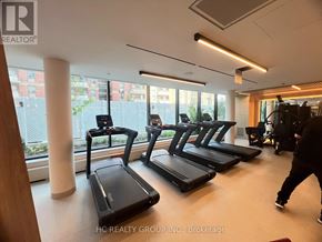 Mississauga (Mississauga Valleys) condo for rent - A gym with treadmills and a person walking by.
