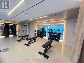 Mississauga (Mississauga Valleys) condo for rent - A gym with a row of black benches and weights.