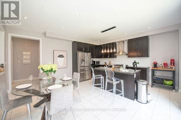 Aurora apartment for rent - A modern kitchen with a dining table set for two.