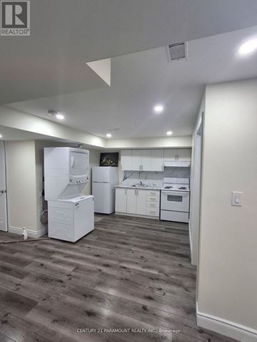 Welland (Dain City) apartment for rent - A kitchen with white appliances and wood flooring.