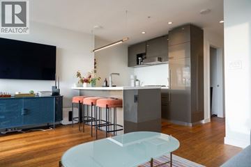 Vancouver apartment for rent - A modern kitchen with a glass table and bar stools.