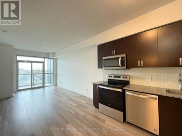 Toronto (Oakwood Village) condo for rent - A kitchen with dark wood cabinets and stainless steel appliances.