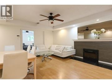 West Vancouver apartment for rent - A living room with a white couch and a wooden floor.