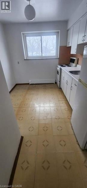 Kitchener apartment for rent - A kitchen with a tile floor and white appliances.
