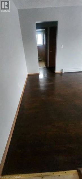 Kitchener apartment for rent - A room with wooden floors and white walls.