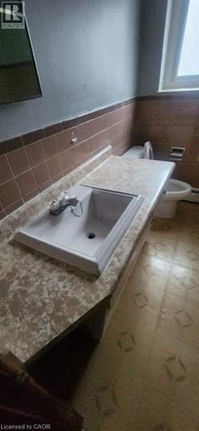 Kitchener apartment for rent - A bathroom with a sink and a toilet.