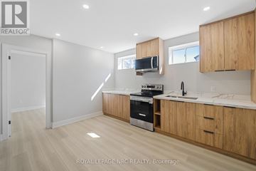Welland (N. Welland) apartment for rent - A kitchen with wooden cabinets and a stainless steel oven.