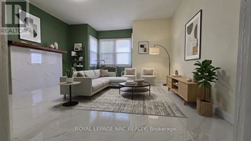 Niagara Falls (Downtown) apartment for rent - A modern living room with a white sofa set and a coffee table.