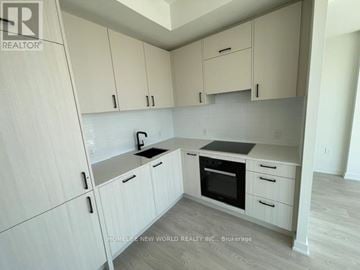 Toronto (Banbury-Don Mills) condo for rent - A kitchen with white cabinets and a black oven.
