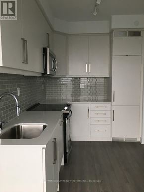 Toronto (Willowdale West) condo for rent - A kitchen with white cabinets and a stainless steel sink.