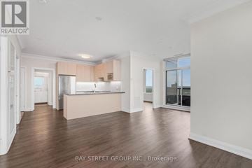 Markham (Unionville) condo for rent - A spacious kitchen with white cabinets and a large island in the middle of the room.