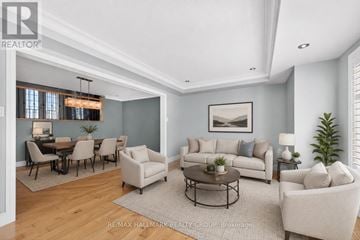 Ottawa apartment for rent - A living room with a grey couch, a coffee table, and a dining table with chairs.