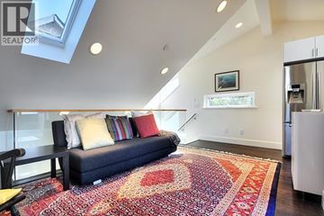 Vancouver apartment for rent - A living room with a couch and a rug.