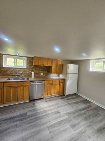 London apartment for rent - A kitchen with wooden cabinets and a white refrigerator.