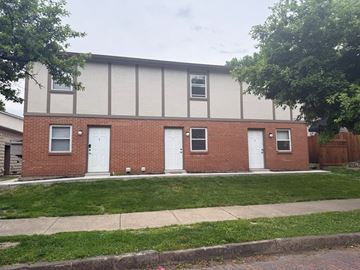 Columbus apartment for rent - A red brick building with white doors and windows.