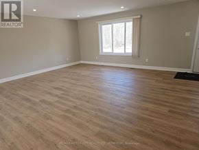Mcnab/Braeside apartment for rent - A room with wooden flooring and a window with white curtains.