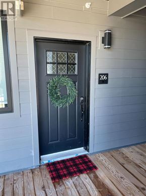 Blue Mountains condo for rent - A black door with a wreath on it.
