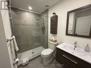 Blue Mountains condo for rent - A bathroom with a toilet, sink, and shower.