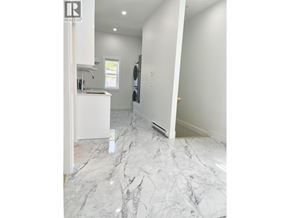 Vancouver apartment for rent - A white marble floor in a room with a window.