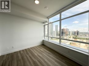Burnaby apartment for rent - A room with a large window overlooking a construction site.