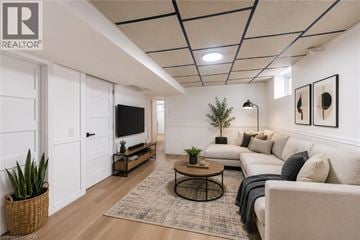 Hamilton apartment for rent - A living room with a white couch, a coffee table, and a flat screen TV.