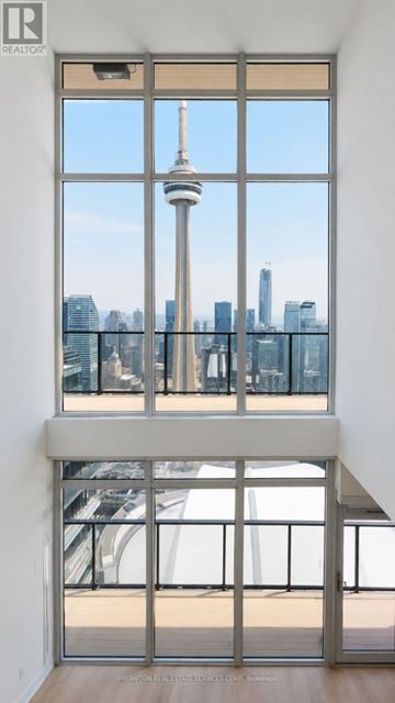 Toronto (Waterfront Communities) condo for rent - A large window with a view of the city skyline.