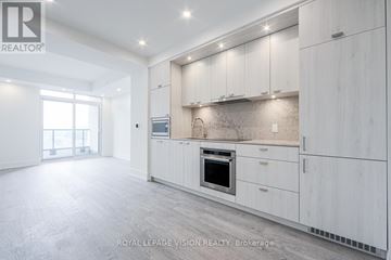 Toronto (Dovercourt-Wallace Emerson-Junction) condo for rent - A spacious kitchen with white cabinets and a large island.