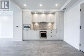 Toronto (Dovercourt-Wallace Emerson-Junction) condo for rent - A modern kitchen with white cabinets and a central island.