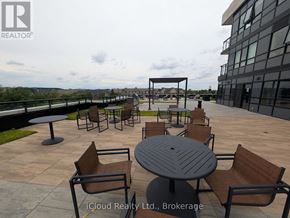 Oakville (Go Glenorchy) condo for rent - A patio with a table and chairs is shown.