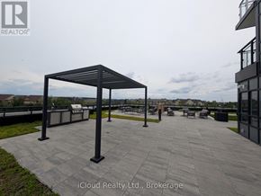 Oakville (Go Glenorchy) condo for rent - A patio area with a roofed seating area and a building in the background.