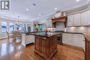 Vancouver apartment for rent - A large kitchen with a wooden island and white cabinets.