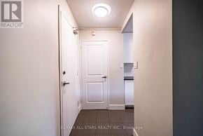 Whitchurch-Stouffville (Stouffville) multi-family for rent - A hallway with a white door and a light on the ceiling.