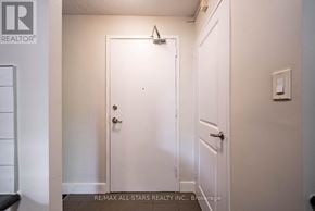 Whitchurch-Stouffville (Stouffville) multi-family for rent - A white door with a handle and a small light on the wall above it.