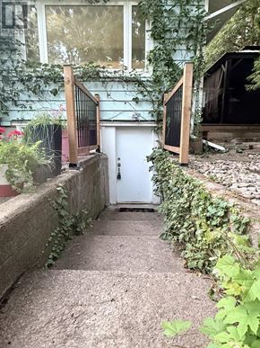 Oakville (Br Bronte) apartment for rent - A white door is at the end of a stone path.