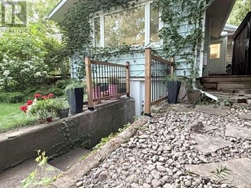 Oakville (Br Bronte) apartment for rent - A blue house with a gate and plants.