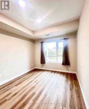 St. Catharines (Oakdale) condo for rent - A room with wooden flooring and a window with curtains.