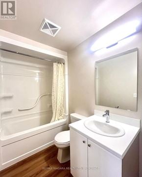 St. Catharines (Oakdale) condo for rent - A white bathroom with a toilet, sink, and bathtub.