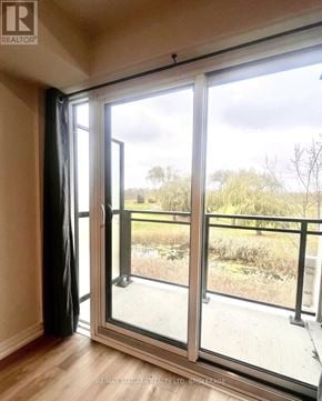 St. Catharines (Oakdale) condo for rent - A room with a sliding glass door leading to a balcony.