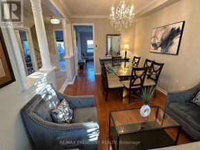 Milton (Cl Clarke) apartment for rent - A living room with a grey couch, a glass table, and a chandelier.